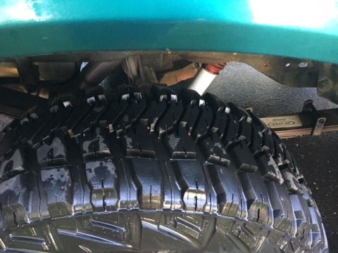 1996 Ford Bronco - A detailed view of a vehicle's undercarriage, focusing on the tire and suspension components.