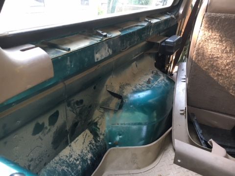 1996 Ford Bronco - This photo shows the interior of a vehicle, focusing on the passenger side where the green metal body is exposed.