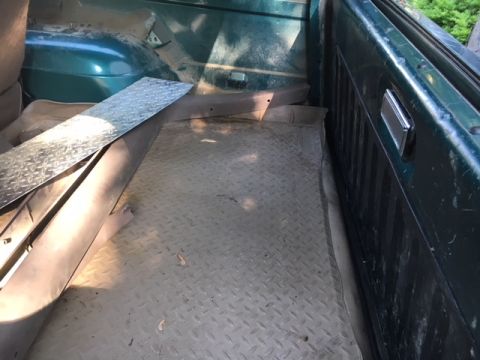 1996 Ford Bronco - The cargo area of a 1996 Ford Bronco shows diamond plate flooring and green interior panels.