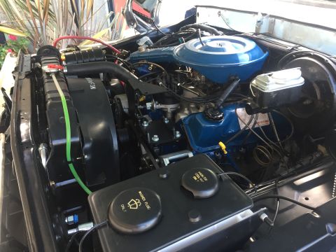 1978 Ford Bronco - Close-up view of a vehicle's engine compartment, showing various components and hoses.