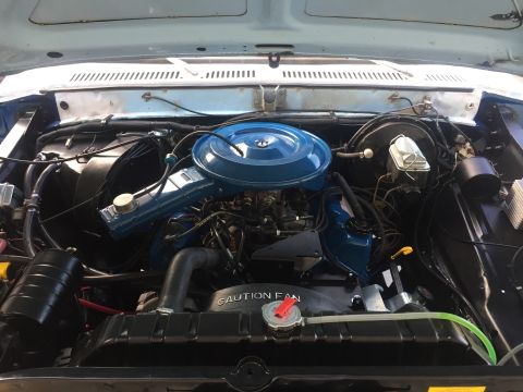 1978 Ford Bronco - The engine bay of a 1978 Ford Bronco, showing the engine components and radiator.