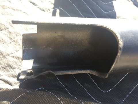 1978 Ford Bronco - black molded plastic component, possibly an interior trim or air duct piece, photographed on a gray padded blanket.