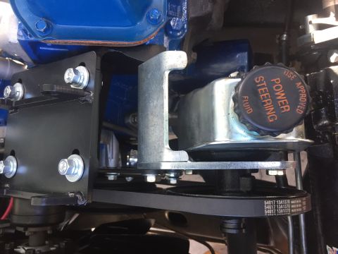 1978 Ford Bronco - Close-up of a power steering fluid reservoir and drive belt assembly.