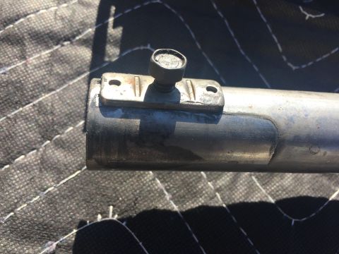 1978 Ford Bronco - Metal pipe with a clamp and bolt assembly, likely a vehicle part.