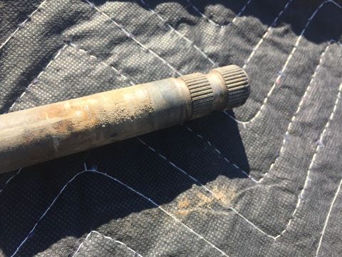1978 Ford Bronco - Close-up of an axle shaft, showing its splined ends resting on a quilted mat.