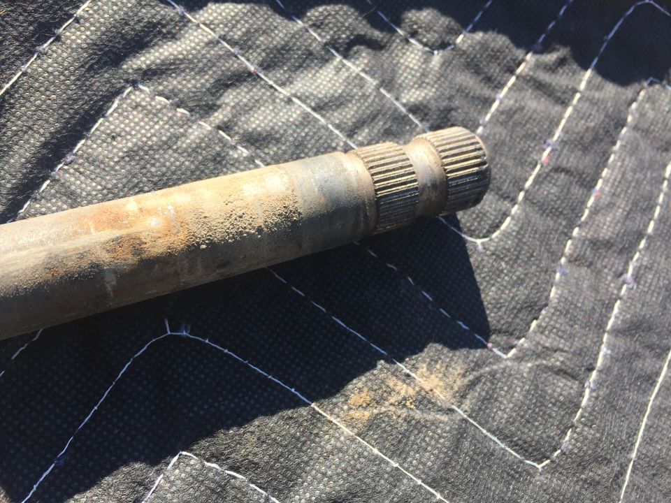 Axle shaft with splined ends on a quilted surface