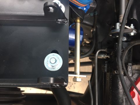 1978 Ford Bronco - Close-up view of steering linkage components, including a mounting bracket and hardware.
