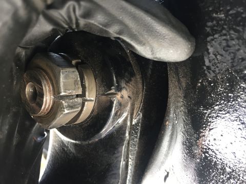 1978 Ford Bronco - Close-up of a wheel hub nut and cotter pin. The image focuses on mechanical components.