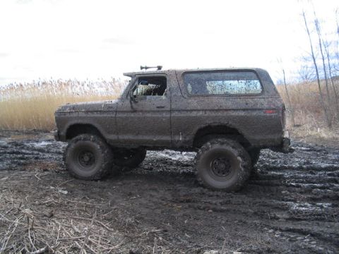 1979 Ford Bronco - This 1979 Ford Bronco is covered in mud after an off-roading adventure in a wet, grassy field.