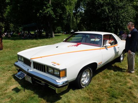 1971 Ford Ranchero - White 1976 Pontiac Grand Am on display at an outdoor event.