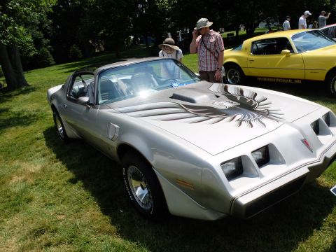 1971 Ford Ranchero - A silver 1977 Pontiac Firebird Trans Am is displayed outdoors with a yellow car nearby.