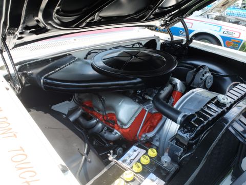 1971 Ford Ranchero - The engine bay of a classic vehicle is shown, a V8 engine and a prominent air cleaner. Text on the fender warns onlookers not to touch.