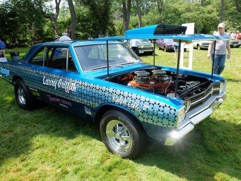 1971 Ford Ranchero - A blue Dodge race car with custom graphics and an open hood is parked on grass at an outdoor event.