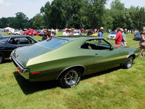 1971 Ford Ranchero - A green 1970 Ford Ranchero is parked on a grassy field with other vehicles and people in the background.