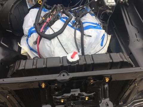 1978 Ford Bronco - The radiator and engine wiring harness are visible in this view of a 1978 Ford Bronco's engine bay.