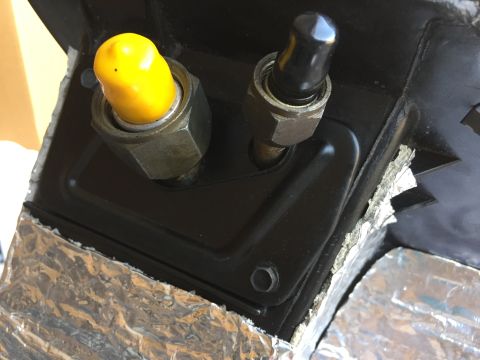 1978 Ford Bronco - Close-up of an AC and heating component yellow and black caps, with foil insulation visible.