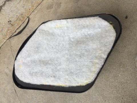 1978 Ford Bronco - An automotive part with white filter material and a black frame is shown on a concrete surface.