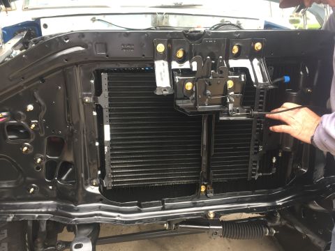 1978 Ford Bronco - Close-up of a vehicle's front end, focusing on the radiator and condenser assembly.