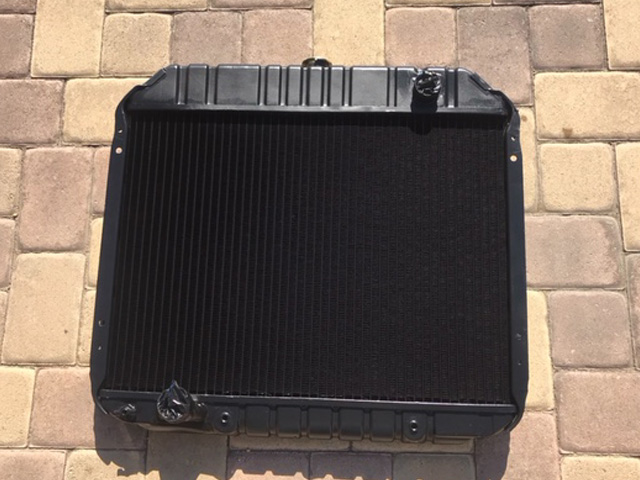 Black radiator with metal fins and cap