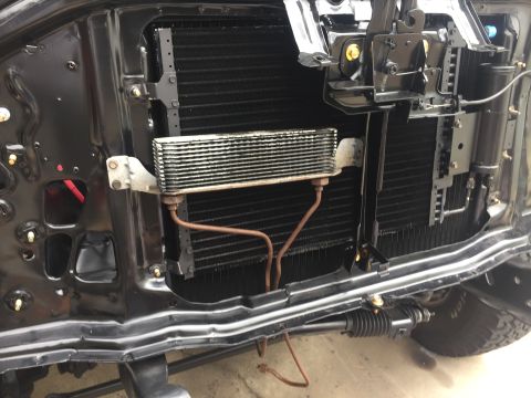 1978 Ford Bronco - Close-up view of the transmission cooler and radiator assembly, showing the intricate network of fins and lines.