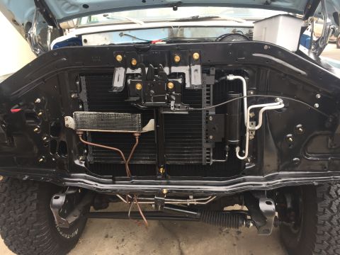 1978 Ford Bronco - Front view of a vehicle's engine bay, highlighting the radiator, AC system, and other engine components.