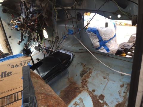 1978 Ford Bronco - Interior of a 1978 Ford Bronco undergoing repairs, with extensive wiring visible and rusted floorboards.