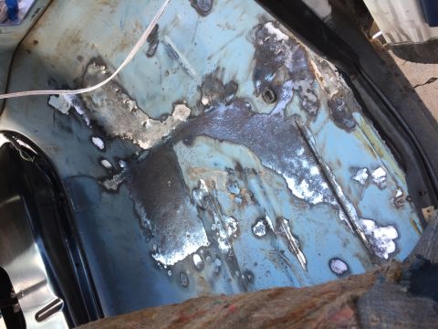 1978 Ford Bronco - The interior floor pan shows significant rust damage and repair work.