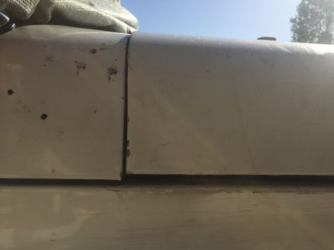1978 Ford Bronco - A close-up view shows the seam between two exterior body panels of a vehicle, with some minor imperfections visible.
