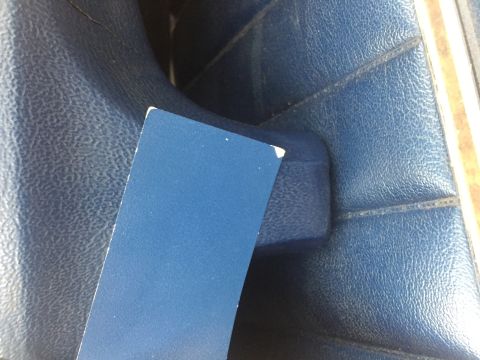 1978 Ford Bronco - Close-up of blue interior upholstery with a blue card in the foreground.
