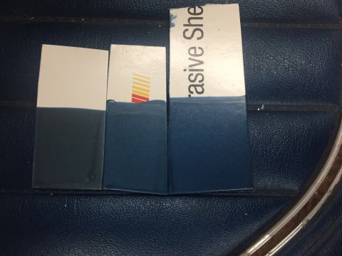 1978 Ford Bronco - Swatches with color samples are placed on a dark blue textured surface, possibly a car interior.
