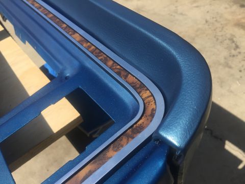 1978 Ford Bronco - Close-up of blue interior trim with woodgrain detail, consistent with a 1978 Ford Bronco.