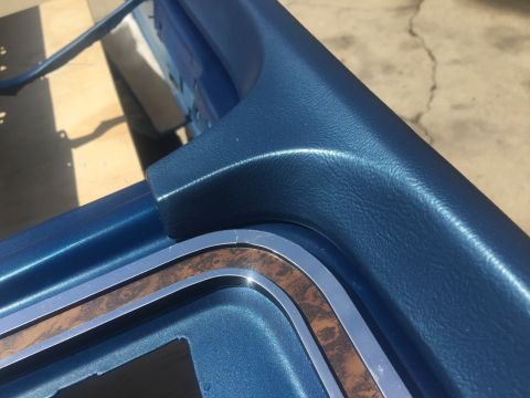 1978 Ford Bronco - Close-up of the blue interior trim a wood grain accent, consistent with a 1978 Ford Bronco.
