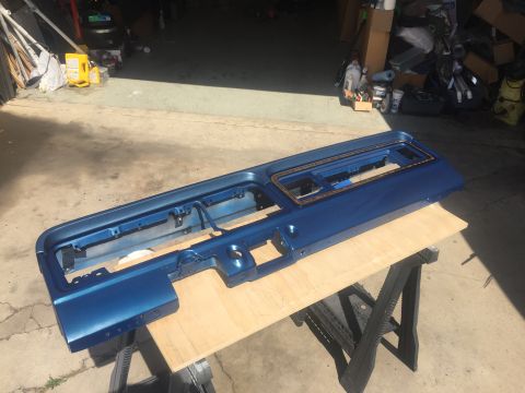 1978 Ford Bronco - Dashboard part painted blue and placed on sawhorses for drying.