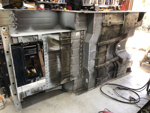 1992 Jeep Wrangler - The underside of a vehicle frame, possibly a Jeep Wrangler, shows extensive repair work with visible welds and metal patches.