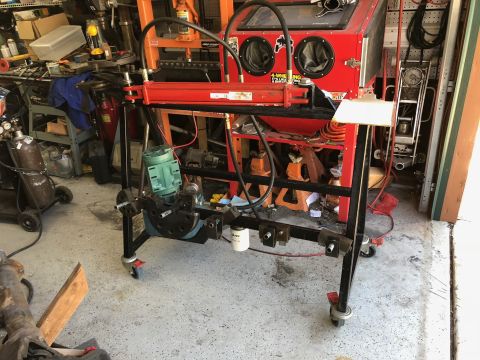 1992 Jeep Wrangler - Workshop scene a hydraulic press and sandblaster with various tools and equipment.