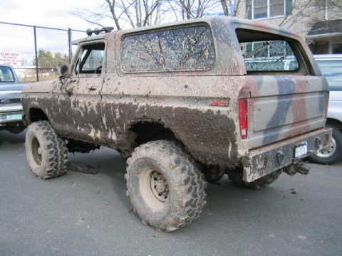 1979 Ford Bronco - This heavily mud-caked 1978 Ford Bronco is viewed from the rear three-quarter angle, showing its camouflage paint job.