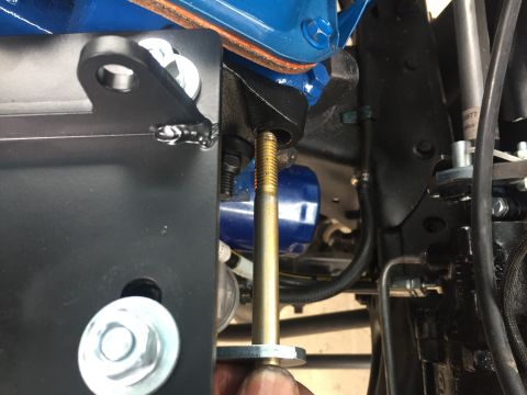 1978 Ford Bronco - Close-up view of an engine component with a bolt and blue oil filter, likely part of a steering system repair.