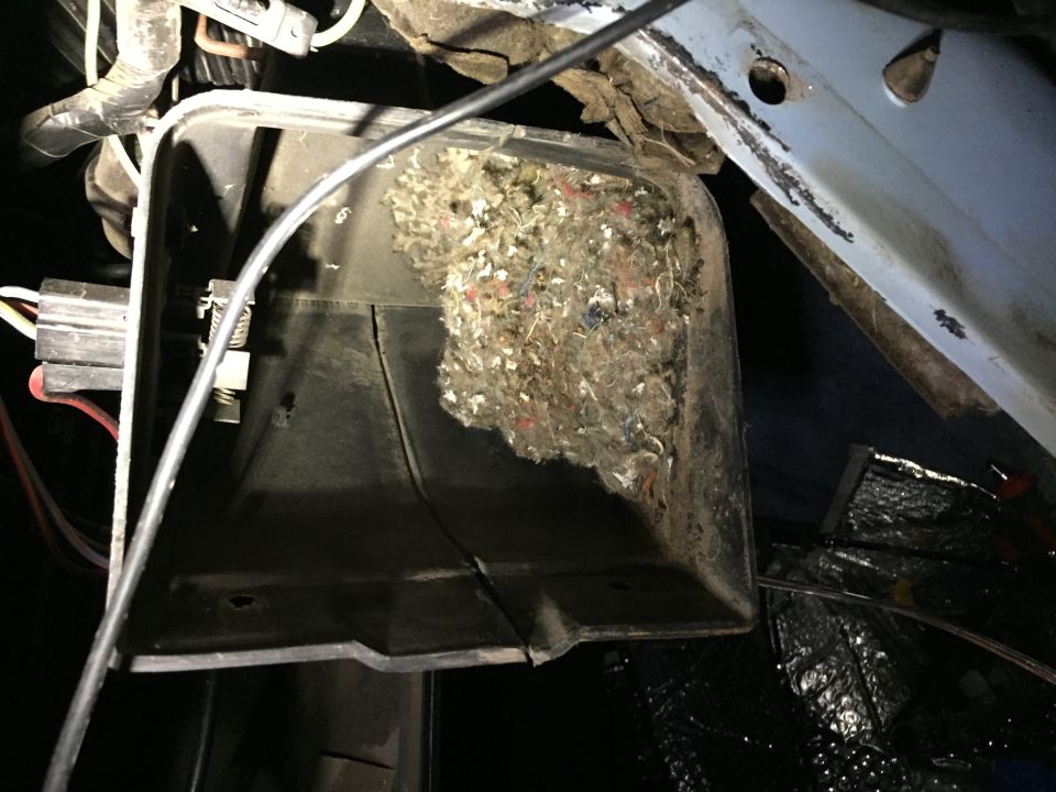 HVAC blower housing packed with debris and insulation