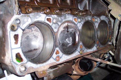1995 Ford Bronco - Close-up view of an engine block's cylinder bores, revealing internal wear and potential damage.