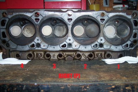 1995 Ford Bronco - Close-up view of an engine cylinder head, showing the intake and exhaust valves and combustion chambers.