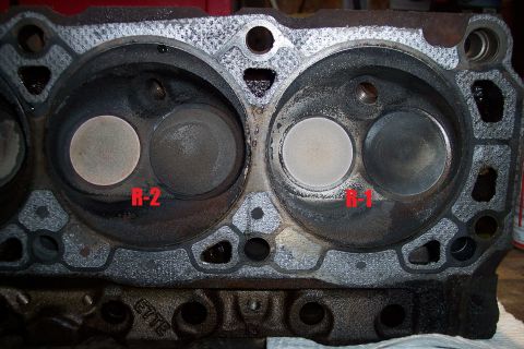 1995 Ford Bronco - Close-up of an engine cylinder head with valves and combustion chambers visible.