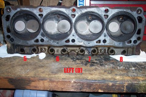 1995 Ford Bronco - A close-up view of an engine cylinder head, showing its internal components and markings.