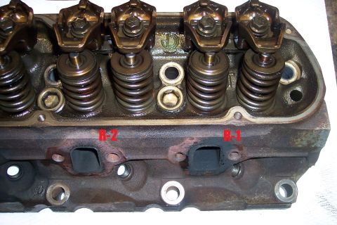 1995 Ford Bronco - Close-up of an engine cylinder head, showing internal components and exhaust ports.