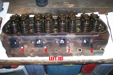 1995 Ford Bronco - Close-up of an engine cylinder head, showing internal components and port labels.