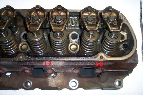 1995 Ford Bronco - This is a close-up view of an engine's cylinder head, showing internal components like rocker arms and valve springs.