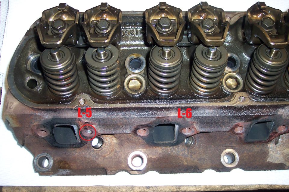 Engine cylinder head with valve springs and rockers, marked L-6