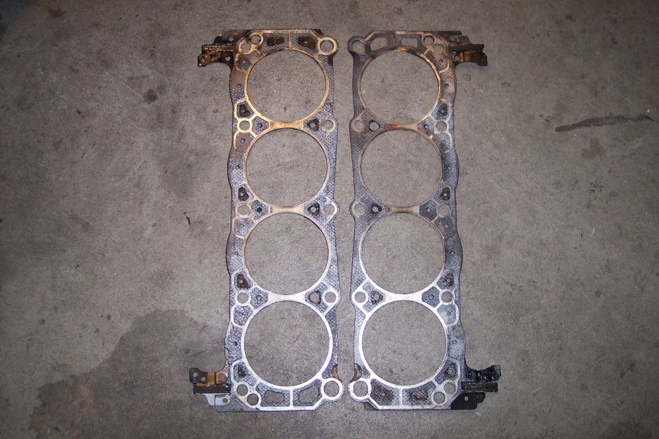 Two engine head gaskets on a concrete floor