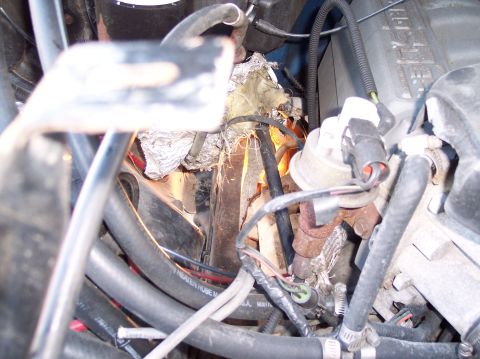 1990 Ford Bronco - A detailed view of various engine components and wiring harnesses within the engine bay.