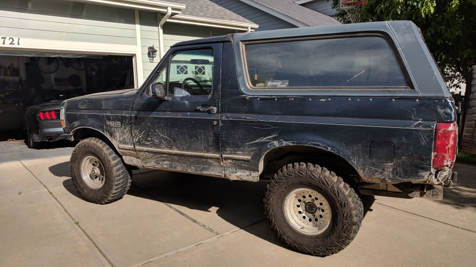 1995 Ford Bronco parked in driveway, side view
