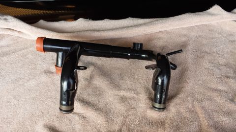 2005 Mercury Grand Marquis - A black metal engine coolant pipe with orange seals is shown on a towel, with a website watermark at the bottom right.